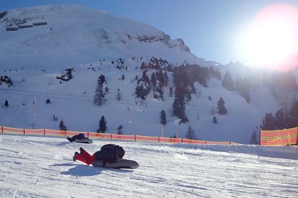 Vader en kind op airboard op de piste